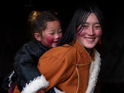 Rosy cheeks and warm garments are reasons to smile for this mother-daughter duo.

