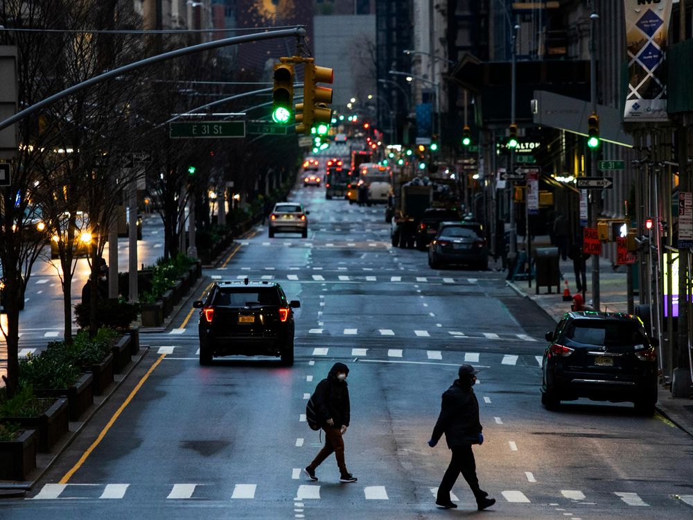 People cross Park Avenue after it was announced that some streets will be closed off as lockdown continues in response to the coronavirus outbreak on March 27, 2020 in New York City.