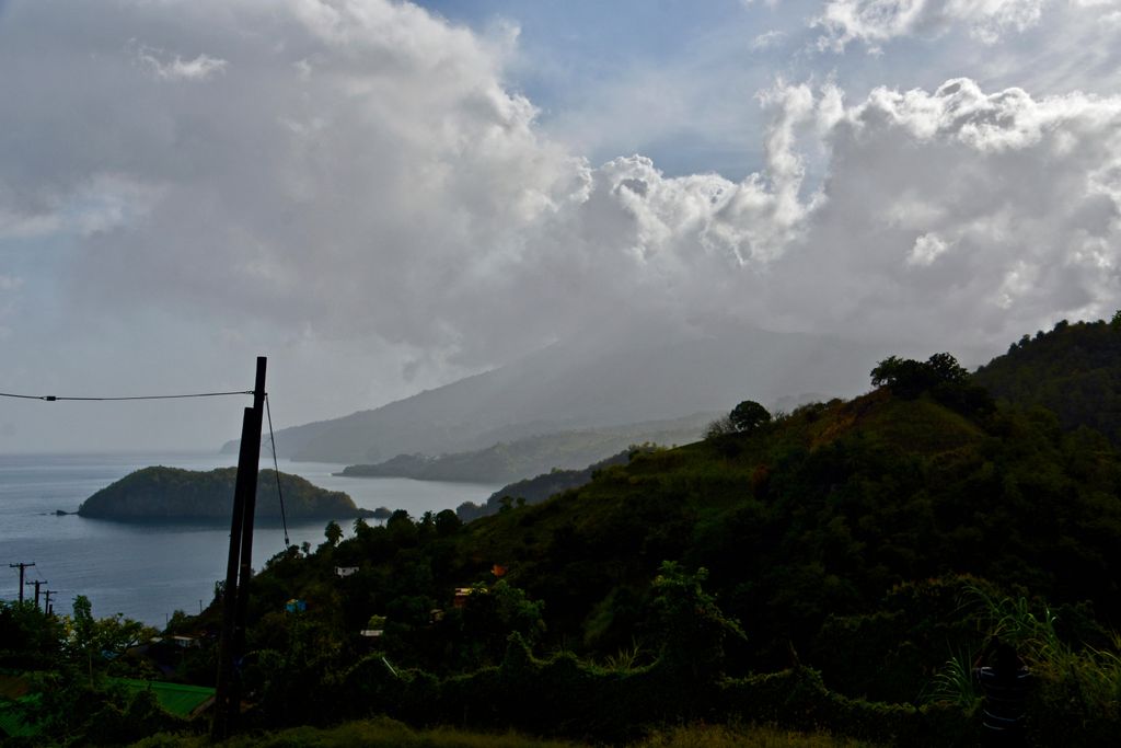 A photograph shows La Soufrière volcano surrounded by ash in the distance