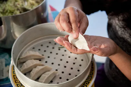 Fold the momo and pinch it closed. 