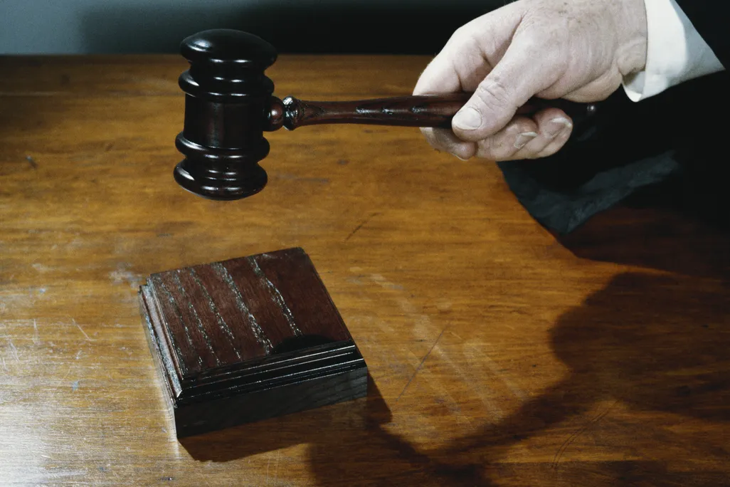 a hand holds a gavel