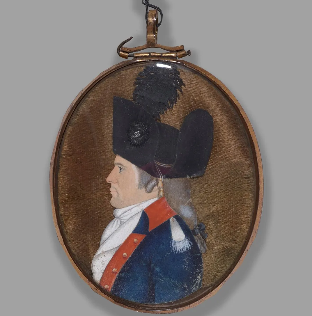 An oval portrait of a white man with gray hair tied in a ponytail, in a bright red and blue suit with a black feathered hat