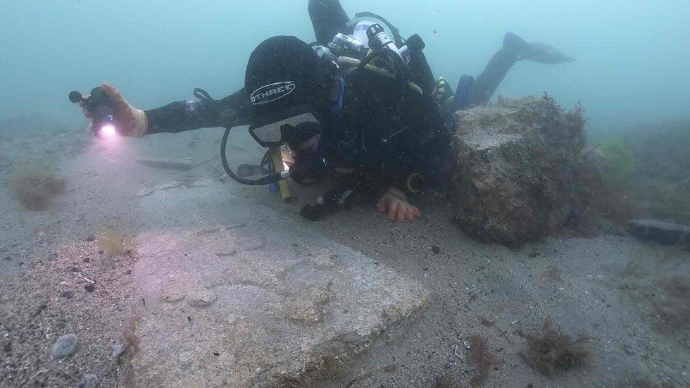 Divers recovered two intricately carved gravestone slabs.