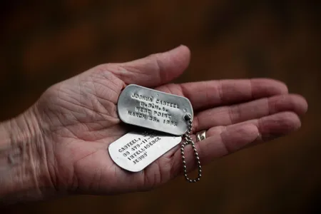 Kristi Casteel holds her son Joshua Casteel's dog tags.