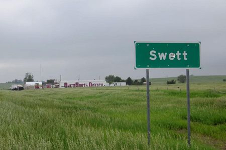 Never fear—Swett, SD's town sign has been replaced with one that doesn't have bullet holes. 