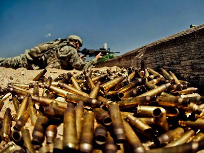 Spent shell casings pile up as a soldier fires his weapon during a U.S. Army weapons qualification.