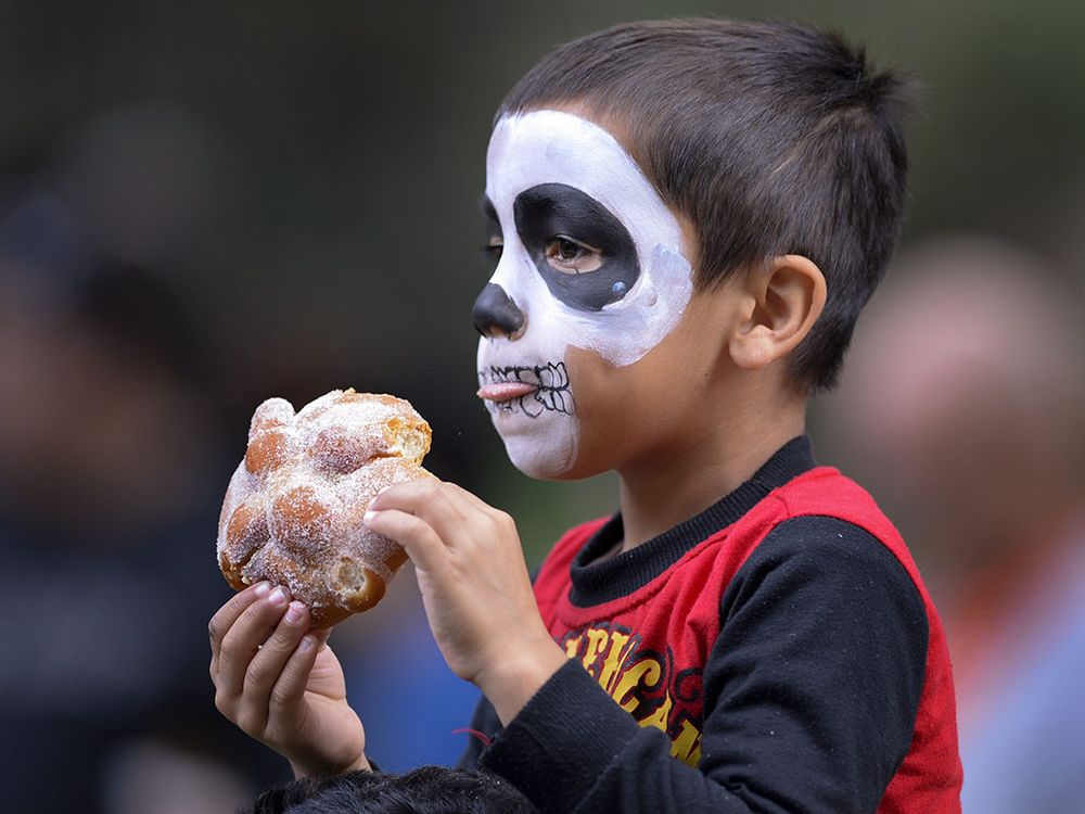 Kid eating pan de muertos