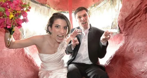 Newlyweds Scott and Amanda Peters inside the mouth of Cabazon Dino Park's Tyrannosaurus