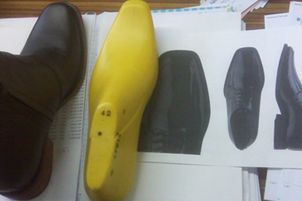 A sample elevator boot, graphic models, and the last on which it was made