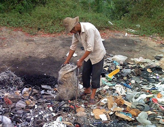 A man sorts through rubbish in Guiyu, the world’s largest center for electronic waste.