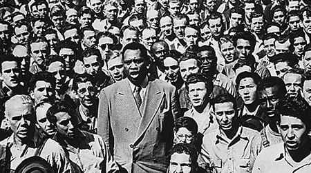 Paul Robeson, in 1942, leads Oakland shipyard workers in the singing of the National Anthem