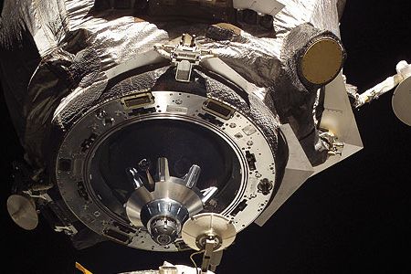 The Soyuz docking assembly's mating adapter is shown in space just feet away from the International Space Station.