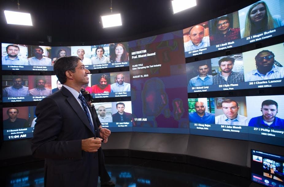 A professor teaches an online class with students from around the world.