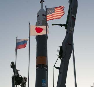 The flags of Russia, Japan, the United States and Kazakhstan are seen flying shortly after the Soyuz TMA-17 spacecraft was raised into vertical position at the launch pad of the Baikonur Cosmodrome, Kazakhstan, Friday, Dec. 18, 2009.  The launch of the Soyuz spacecraft with Expedition 22 NASA Flight Engineer Timothy J. Creamer of the U.S., Soyuz Commander Oleg Kotov of Russia and Flight Engineer Soichi Noguchi of Japan, is scheduled for Monday, Dec., 21, 2009 at 3:52a.m. Kazakhstan time.  Photo Credit (NASA/Bill Ingalls)