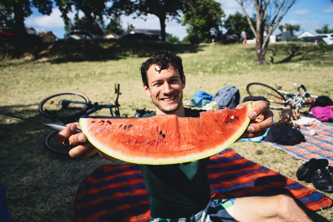 A man with a big slice of watermelon