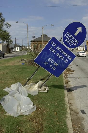 Sign marking an evacuation route, tilted by the storm. Photograph by Hugh Talman.