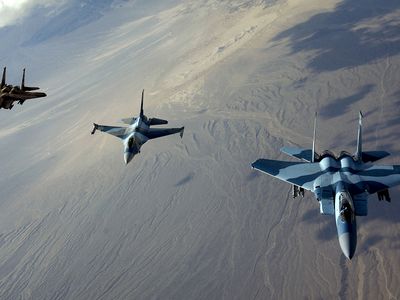 Tough-guy F-15s flank a grown-up F-16 over Nellis Air Force Base, Nevada, in 2007. 