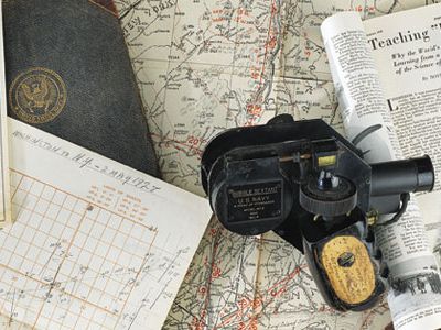 In May 1928, Navy Lieutenant Commander Philip V.H. Weems took Charles Lindbergh on a series of flights to teach him a new way to navigate. Clockwise from left: Lindbergh’s sun lines of position, plotted from Washington, D.C., to New York to Michigan; Weems’ personal log; the bubble sextant used in Lindbergh’s training; an article in Popular Science that documented the lessons; and Weems’ book on line of position.