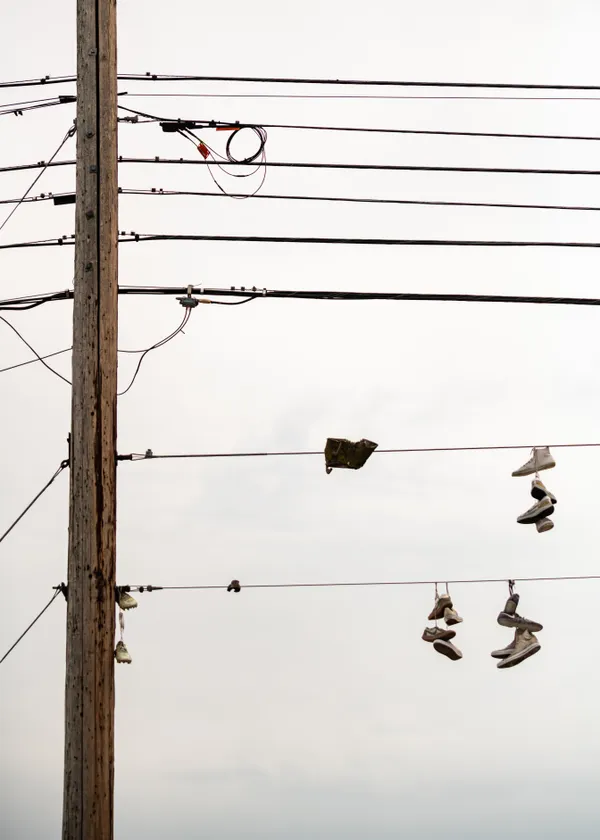 Shoes hanging from power lines thumbnail