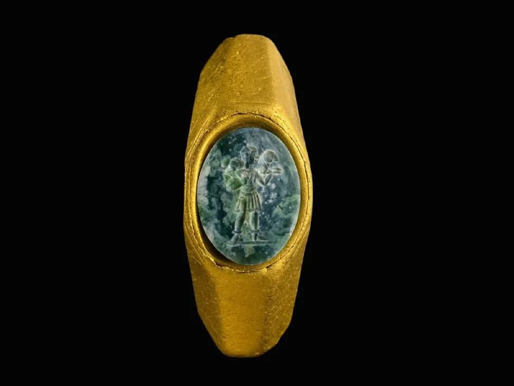 Gold ring with green gemstone carved with shepherd image
