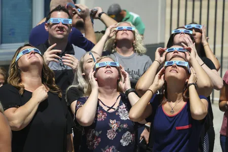 Texas Motor Speedway staff watch the August 21, 2017, total solar eclipse through special eclipse glasses.