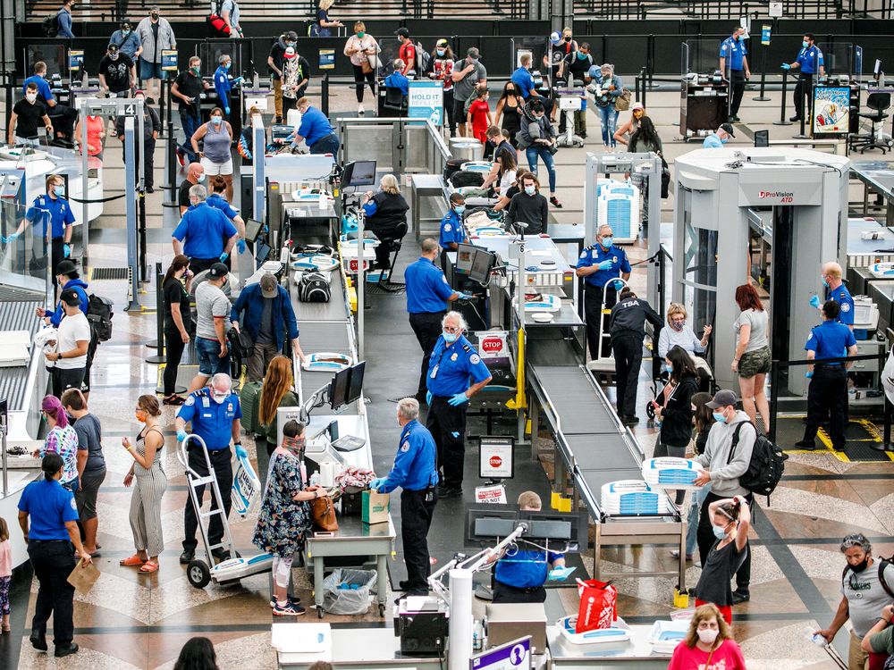 Passengers going through security at Denver airport