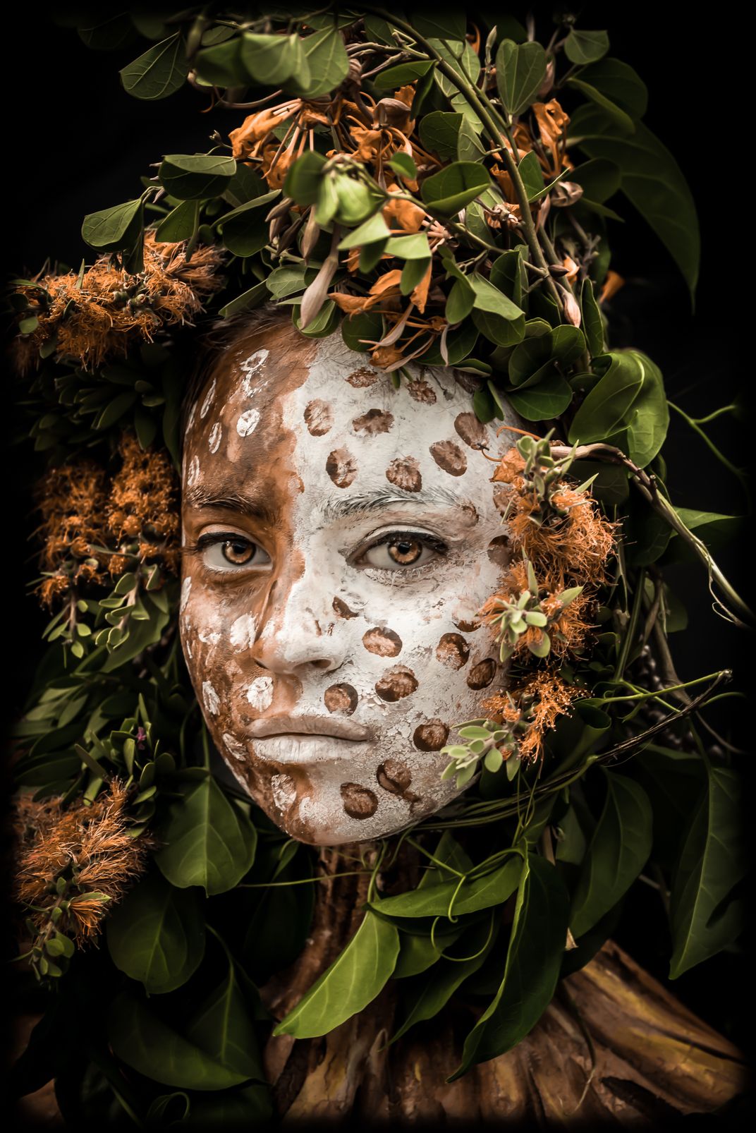 A indigenous young girl with face paint