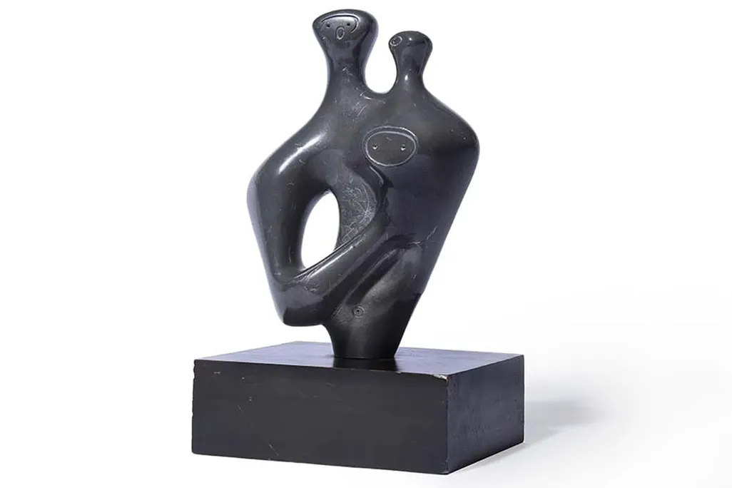 abstract lead statue of two humanlike figures embracing