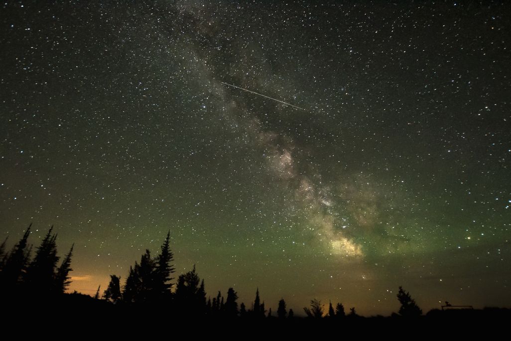 A shooting star streaks across a star-filled sky in British Columbia