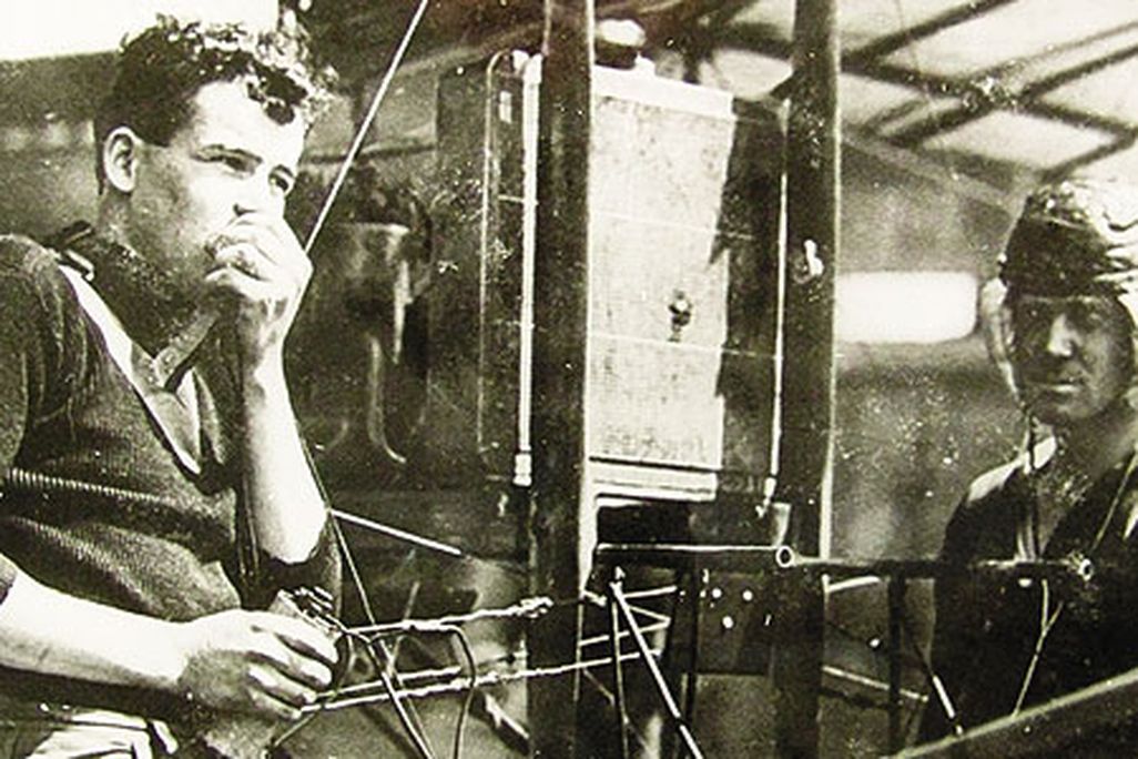Just months after Lieutenant Paul Beck made an early airborne radio transmission, aviators test a receiving set - with the airplane's engine running - on North Island, Washington.