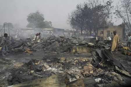Nigerian boys sift through the remains of the Gamboru market after multiple explosions took place Maiduguri, northern Nigeria, on February 7, 2012. Boko Haram claimed responsibility for the attacks. 