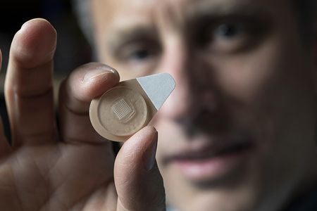 Mark Prausnitz holds an experimental microneedle contraceptive skin patch. Designed to be self-administered by women for long-acting contraception, the patch could provide a new family planning option.