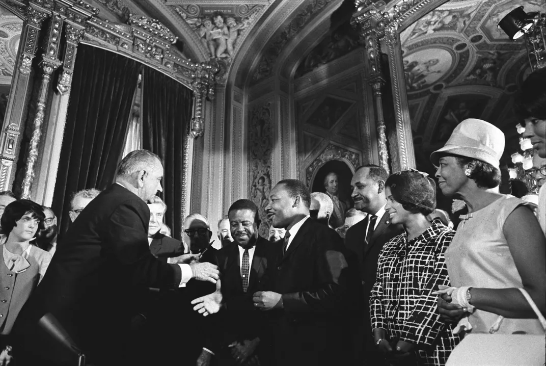 President Lyndon B. Johnson, Martin Luther King Jr. and Rosa Parks at the signing of the Voting Rights Act on August 6, 1965