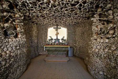 From the road, it would be easy to overlook this small, unassuming chapel located in one of the oldest towns in southwestern Poland. But the wooden doors hide a spectacular, macabre interior. The skulls and leg bones of over 3,000 victims of wars and plagues cover the walls and ceiling, and a crypt below, accessible through a trapdoor, houses over 21,000 additional remains. Between 1776 and 1804, the local priest, Vaclav Tomasek, painstakingly gathered, cleaned and carefully arranged skeletons recovered from numerous, shallow mass graves left by the Thirty Years’ War, Silesian Wars and cholera outbreaks. Modeled off of similar ossuaries and catacombs in Rome, the chapel was intended as a shrine for the dead, as well as a “memento mori” for the living. 

On the church’s altar, Tomasek placed the bones of important figures and curiosities, including the skull of the local mayor, skulls with bullet holes, a skull deformed by syphilis and the bones of a supposed giant. When the chapel's creator passed away in 1804, his skull was placed on the altar as well.

View the photos above or explore the 360° interactive panorama on  Kaplica Czaszek’s official site  (in Polish).
