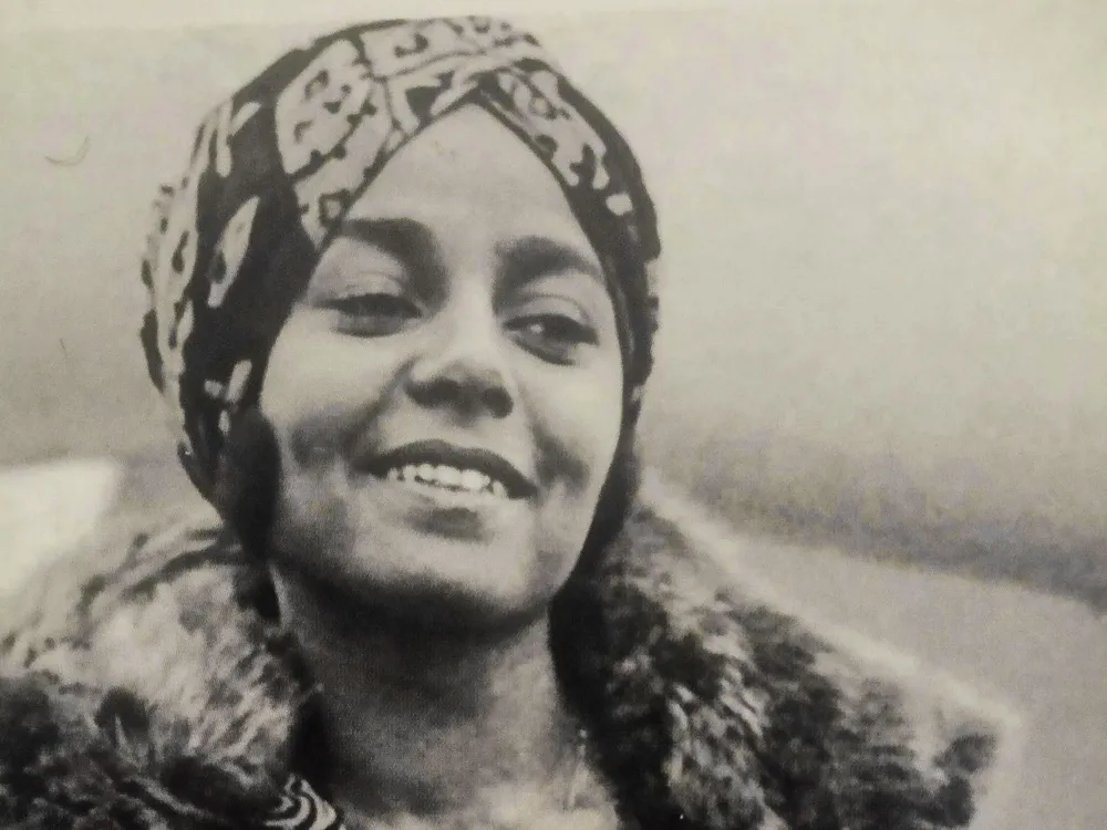 Black-and-white photograph of Stephanie St. Clair, smiling while looking away from the camera