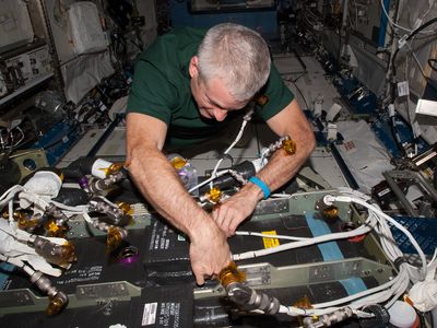NASA's Steve Swanson works on the Carbon Dioxide Removal Assembly on the International Space Station in April 2014.