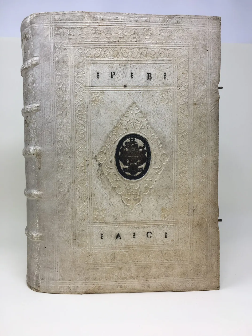 Rare book with white pigskin binding and metal hardware.