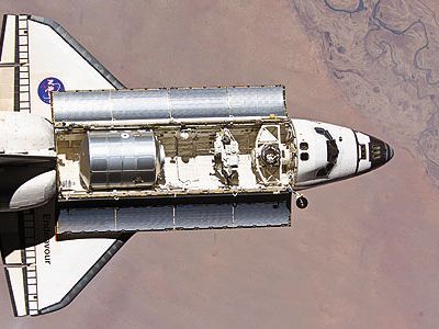 The shuttle main engine is the most tested large rocket engine in the world. In 1996, a turbine component (displayed here by a NASA scientist) underwent airflow tests to help engineers create more eff