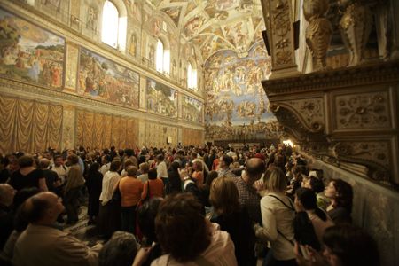 Tourists crowd the Sistine Chapel