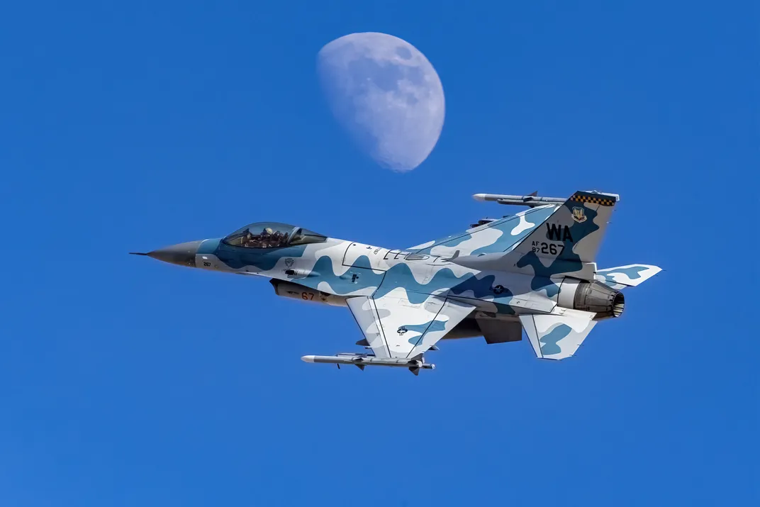 9 - A pilot in a colorful aircraft seemingly flies just a few yards from the moon.