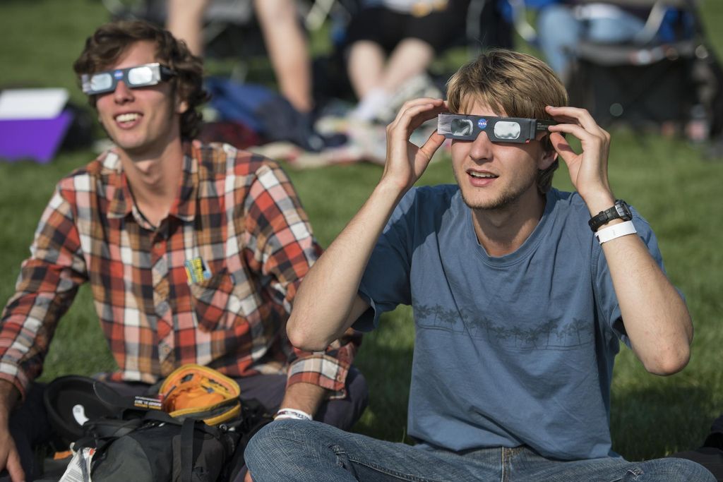 Two men wearing eclipse glasses
