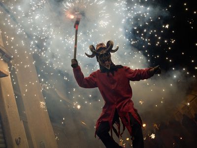 A devil burns gunpowder during the festival of Els Foguerons de Sa Pobla.