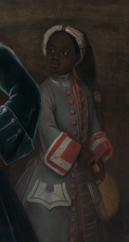 A close up version of a young Black boy of African descent, who wears red and grey livery and is in the act of pouring wine for the wealthy men