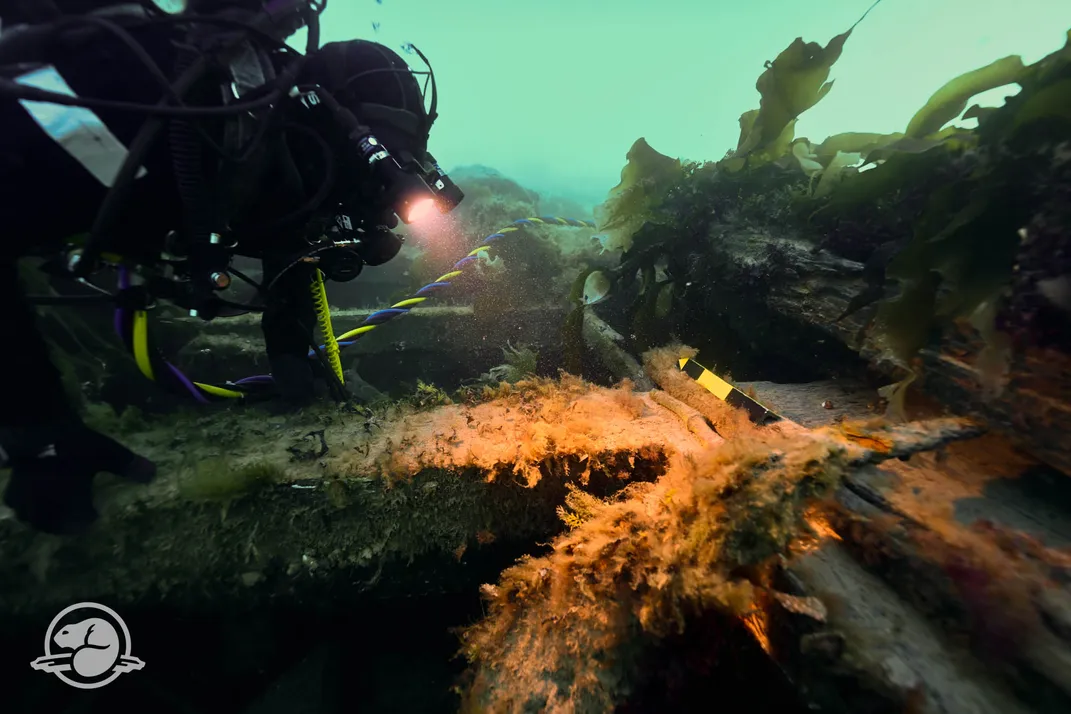 Archaelogist exploring shipwreck underwater