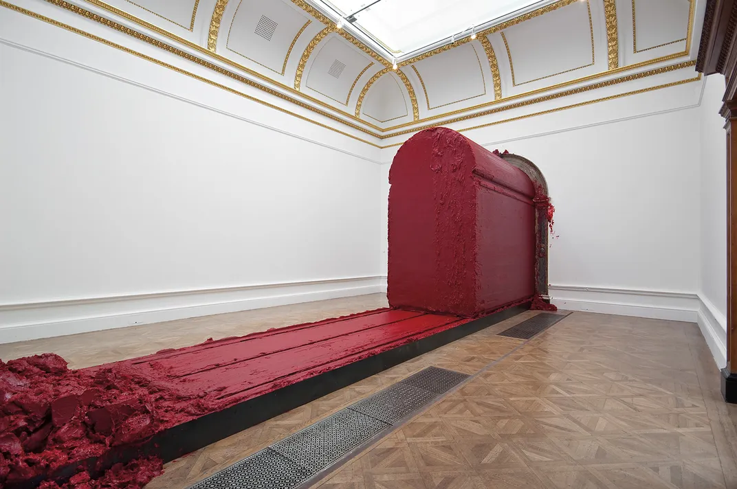 The wax- and oil-based Svayambhu moves slowly through the Royal Academy of Arts in London, leaving a sticky trail of goo.
