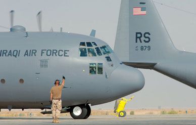 An Iraqi Air Force C-130 gets a thumbs-up from a U.S. Air Force crew chief during a July 2005 mission from Ali Air Base.