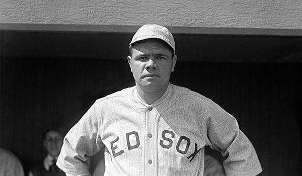 Babe Ruth, wearing a Red Sox uniform, looks squarely at the camera