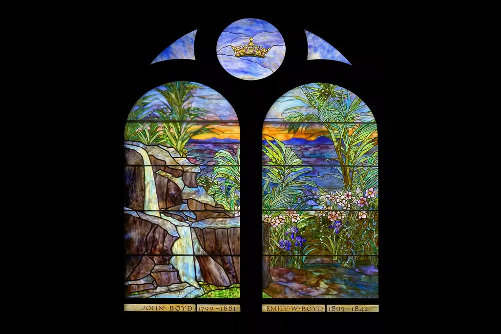 A colorful stained-glass window with a black background