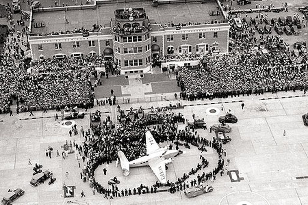 On July 14, 1938, thousands gathered for the return of Howard Hughes, who in four days had flown a Lockheed Super Electra around the world.