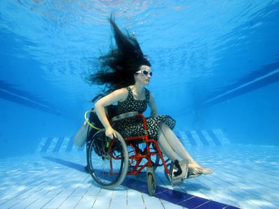 Artist Sue Austin scopes out a pool in her underwater wheel chair.